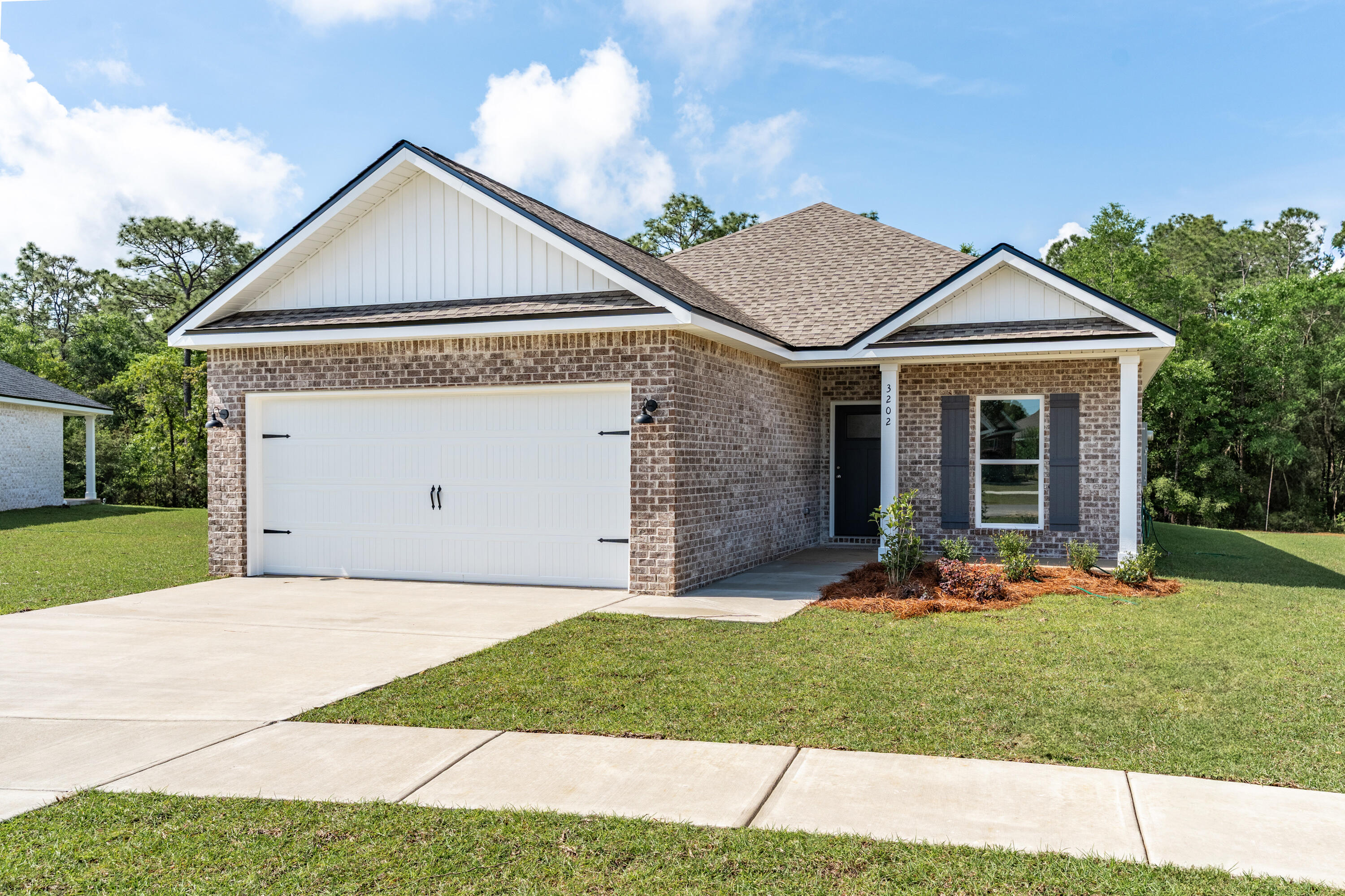 3202 Oxmore Drive Crestview, FL 32539 - Photo 1 of 20 a front view of a house with a yard and garage