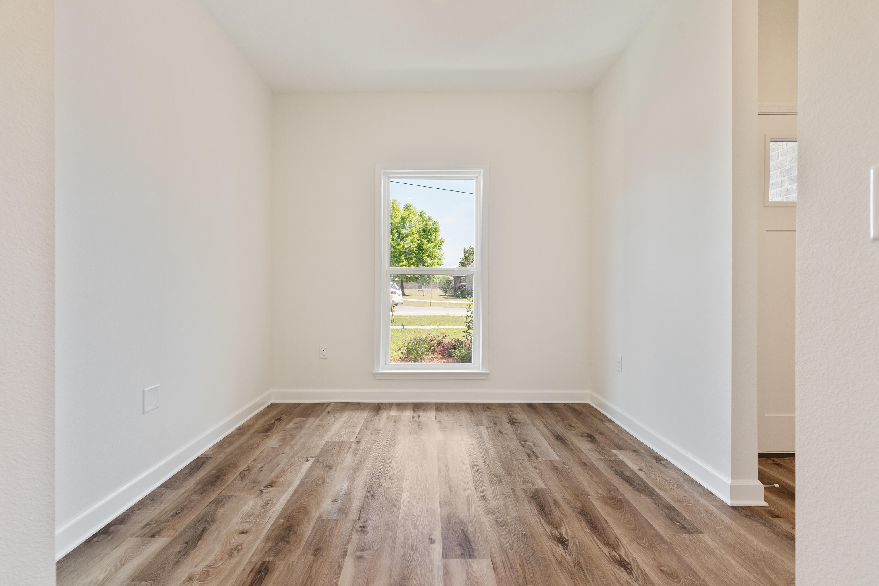 3202 Oxmore Drive Crestview, FL 32539 - Photo 11 of 20 wooden floor in an empty room with a window