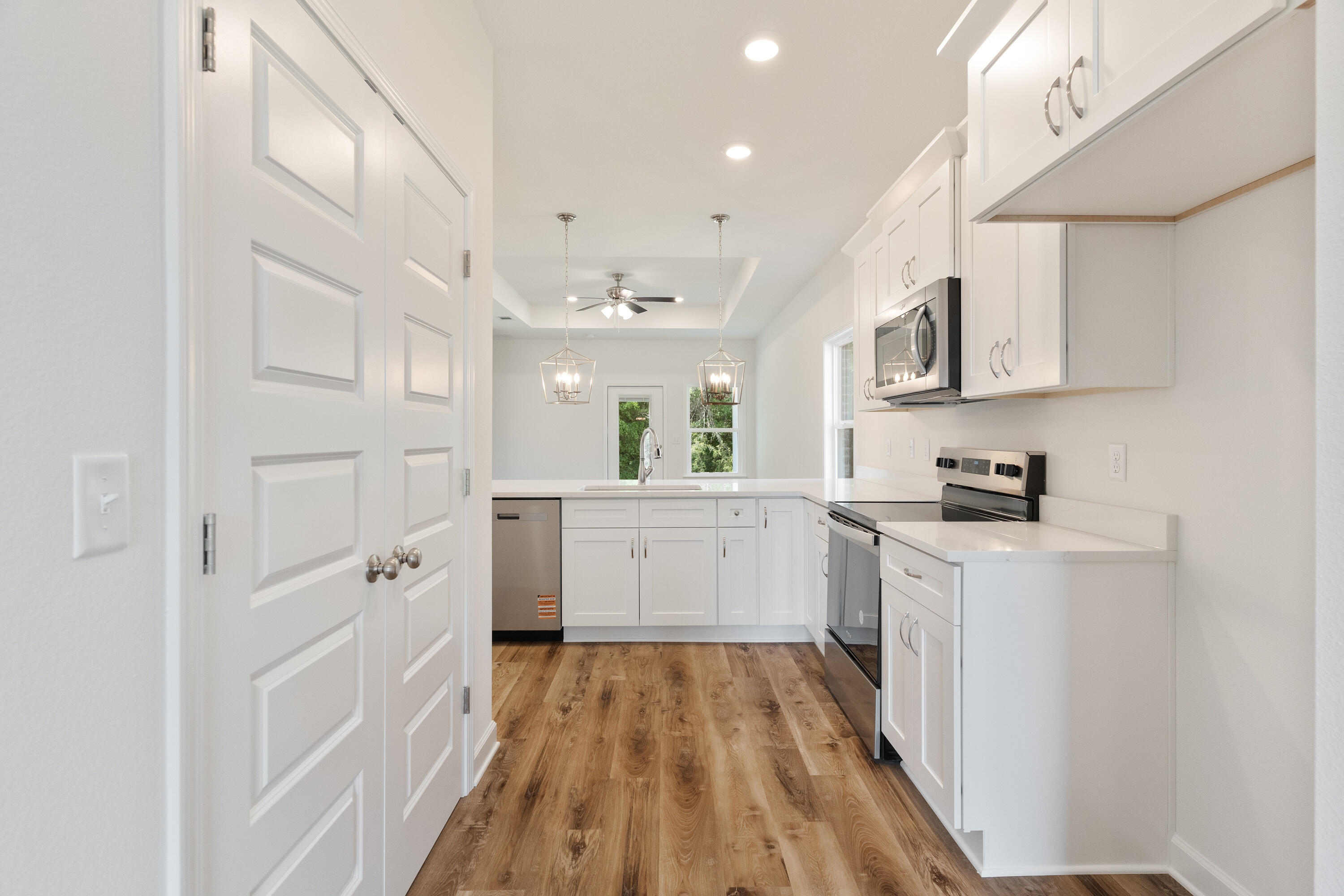 3202 Oxmore Drive Crestview, FL 32539 - Photo 3 of 20 a kitchen with white cabinets and white appliances