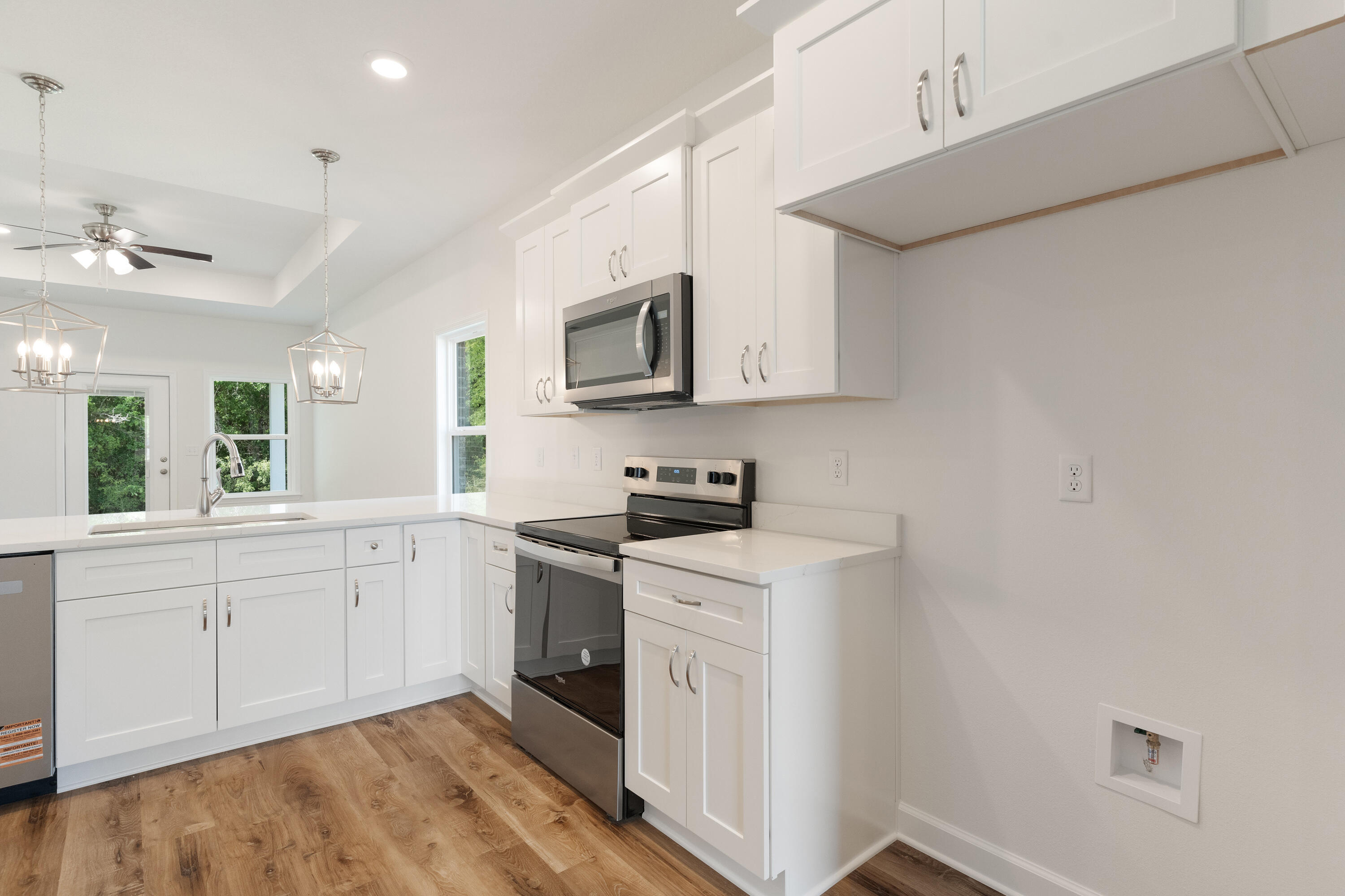 3202 Oxmore Drive Crestview, FL 32539 - Photo 4 of 20 a kitchen with stainless steel appliances granite countertop a stove a sink and a microwave