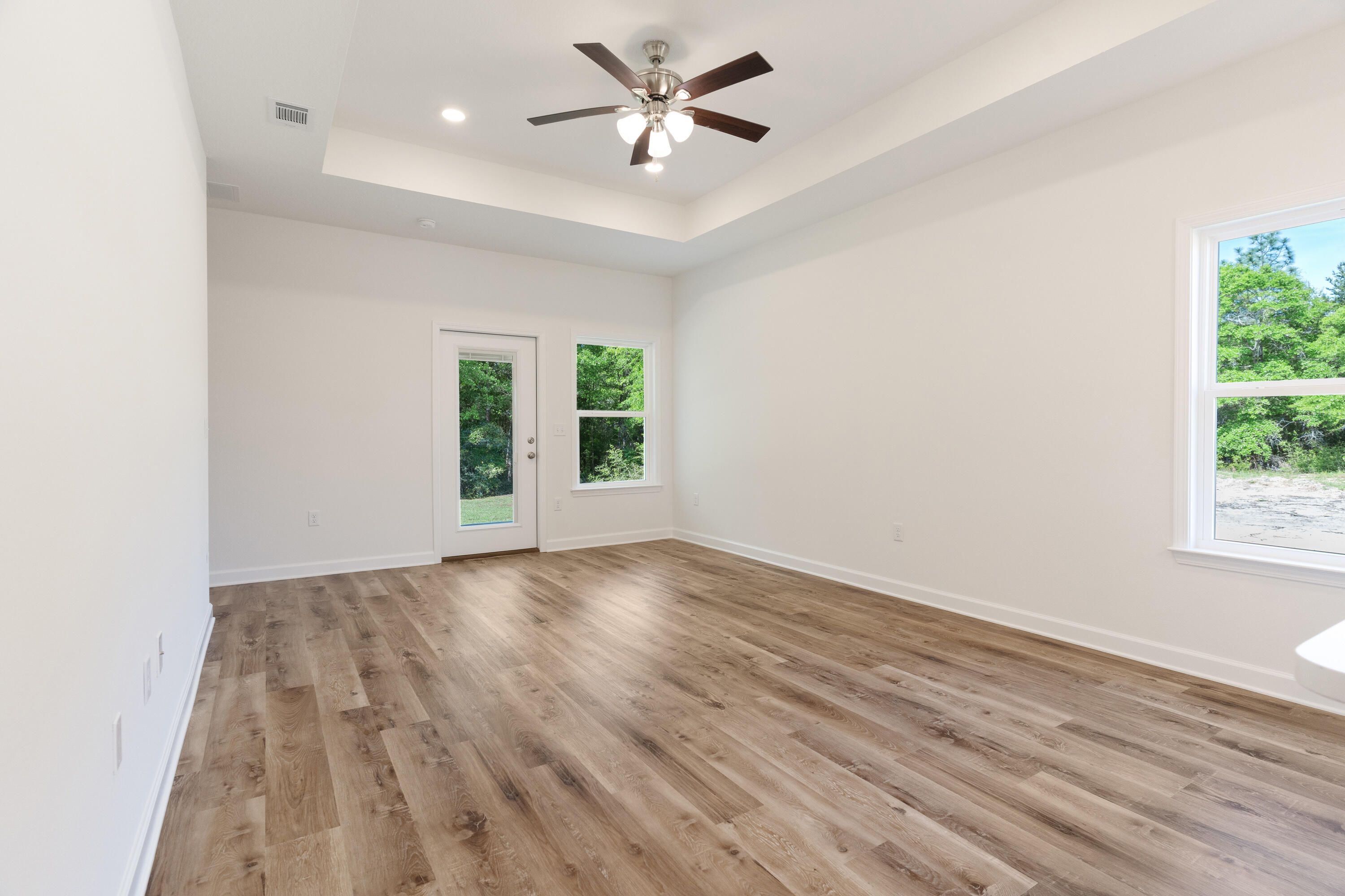 3202 Oxmore Drive Crestview, FL 32539 - Photo 8 of 20 wooden floor in an empty room with a window