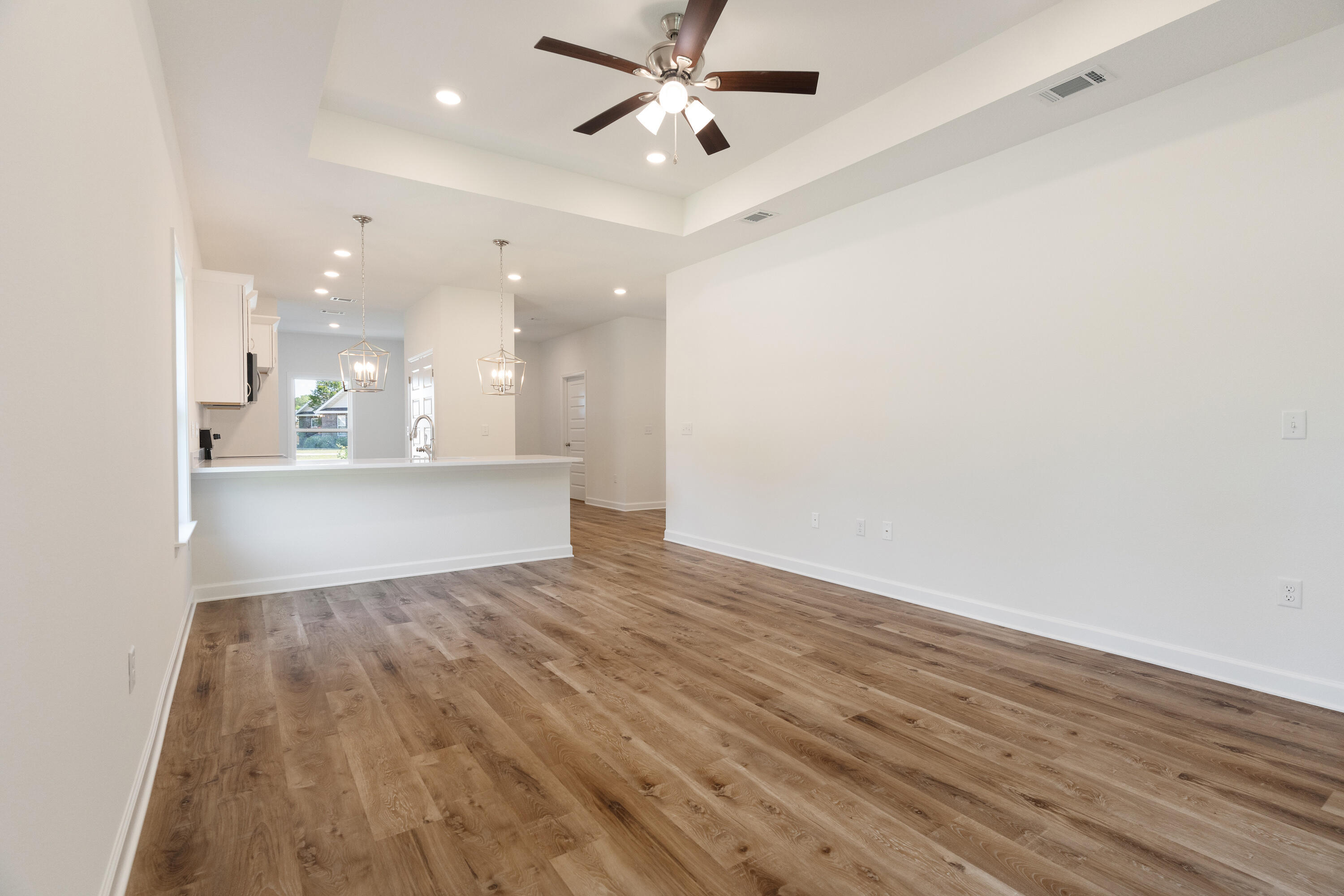 3202 Oxmore Drive Crestview, FL 32539 - Photo 9 of 20 an empty room with wooden floor and windows