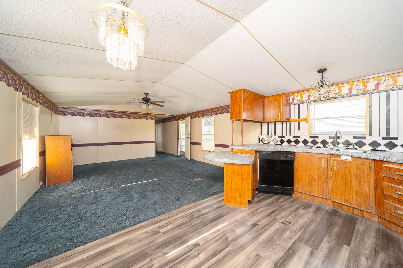4603 Crosby Cedar Bayou Road Baytown, TX 77521 - Photo 9 of 14 a view of a living room and kitchen with furniture wooden floor and a window