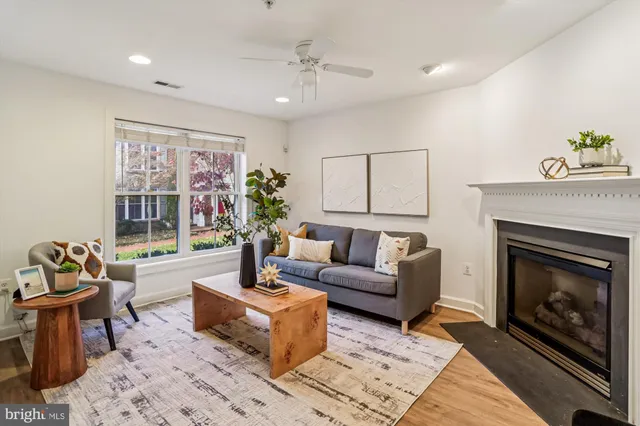 a living room with furniture a fireplace and a table
