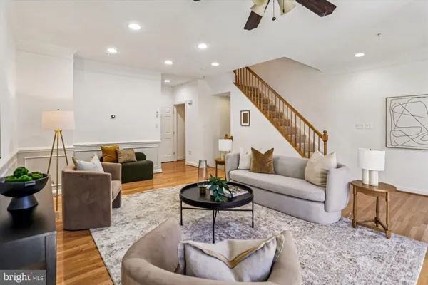 a living room with furniture a rug and a chandelier