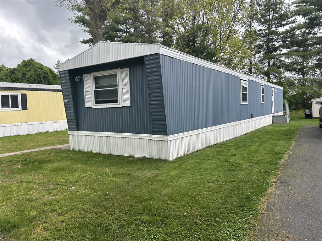 735 Memorial Drive, Unit 115 Chicopee, MA 01020 - Photo 2 of 8 a view of a house with a yard