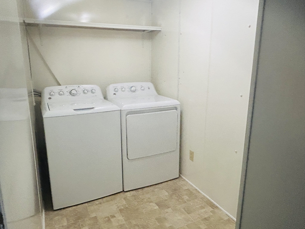 735 Memorial Drive, Unit 115 Chicopee, MA 01020 - Photo 6 of 8 a utility room with dryer and washer