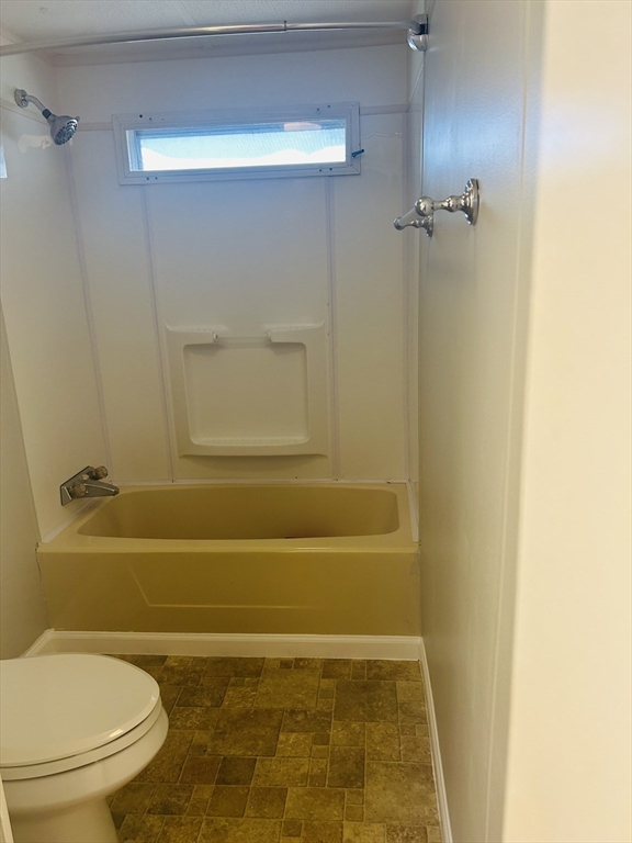 735 Memorial Drive, Unit 115 Chicopee, MA 01020 - Photo 7 of 8 a bathroom with a toilet and a bathtub
