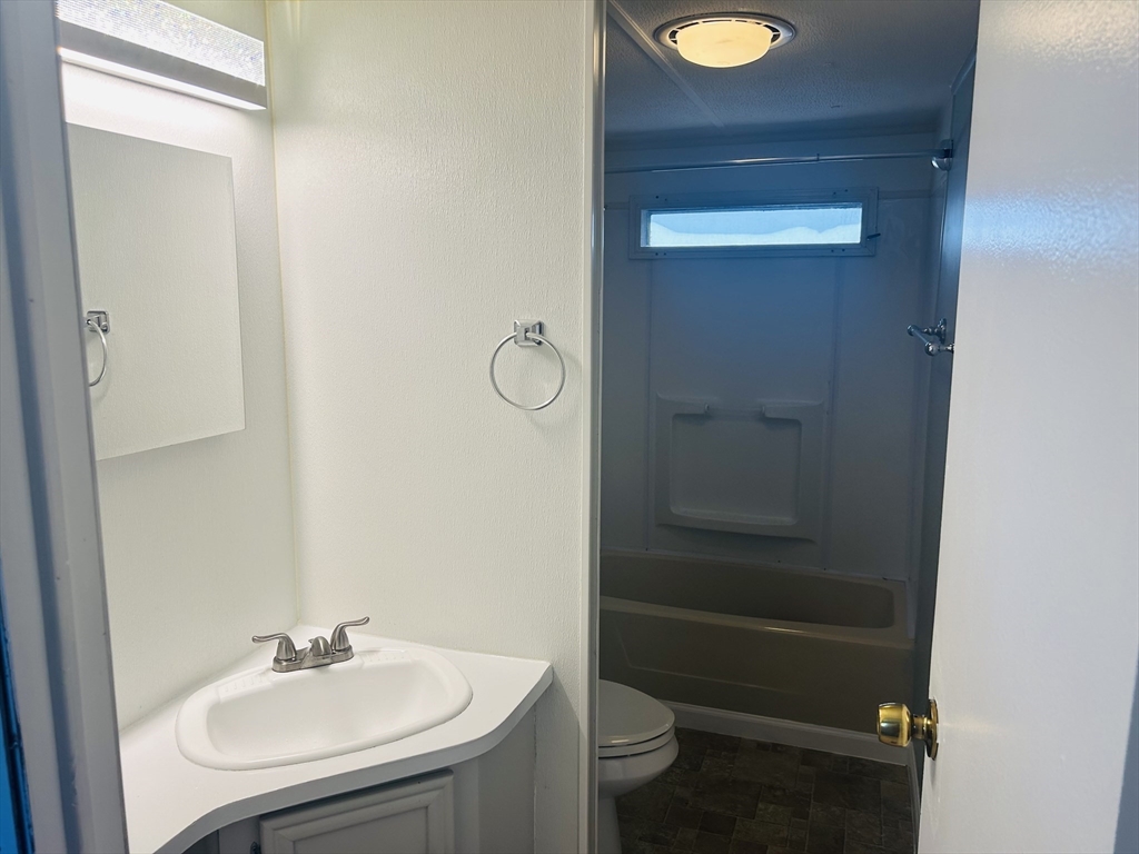 735 Memorial Drive, Unit 115 Chicopee, MA 01020 - Photo 8 of 8 a bathroom with a sink and a toilet