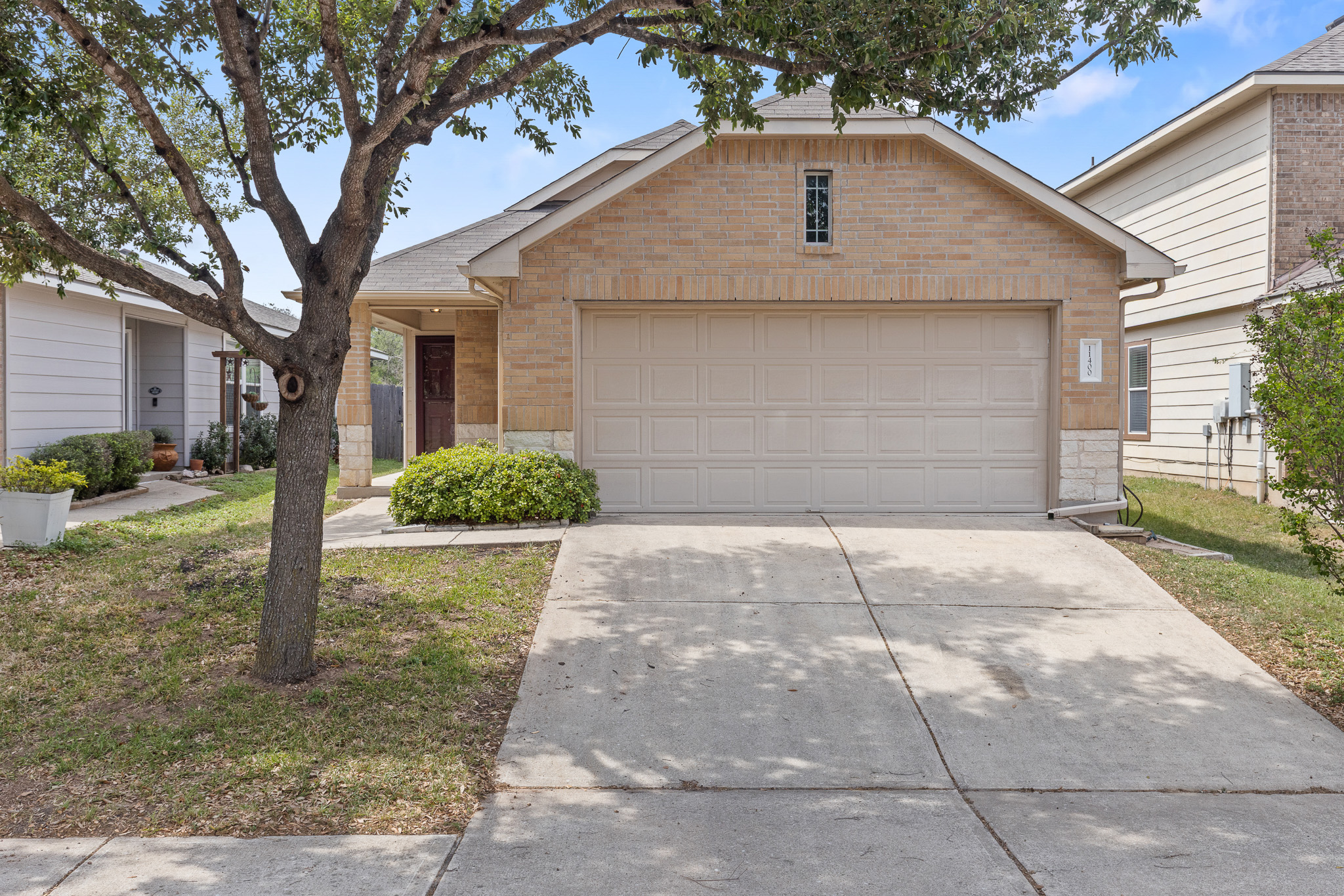 a front view of a house with a yard and garage