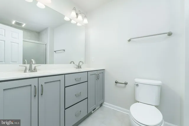 a bathroom with a glass door shower