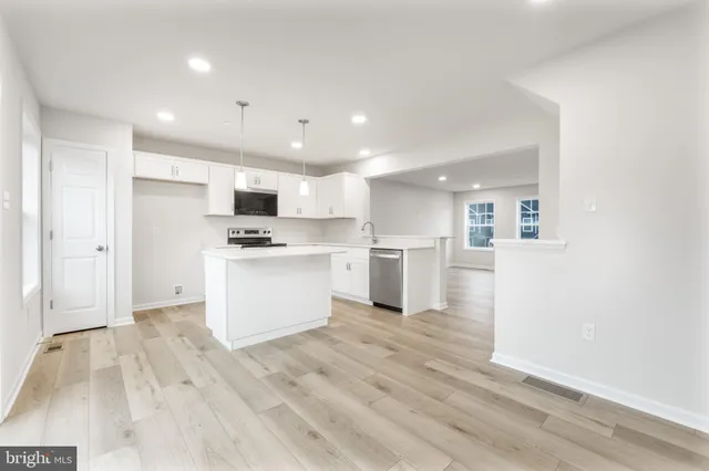 a kitchen with a white wooden cabinets and white appliances