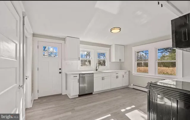 a spacious bathroom with a granite countertop tub and a sink