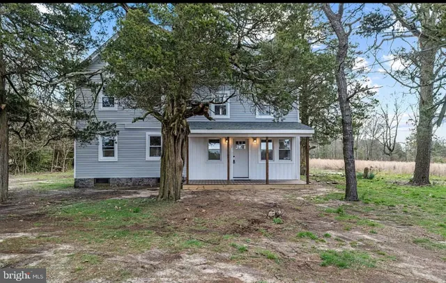 a front view of house with yard and trees
