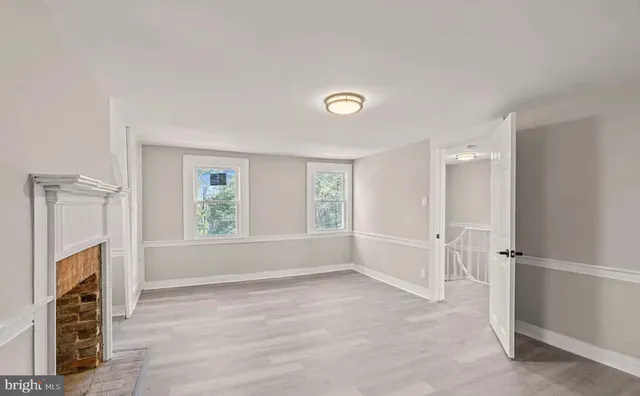 a view of livingroom with hardwood floor and a fireplace