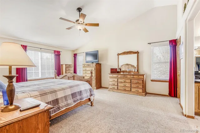 a bedroom with furniture and a large window