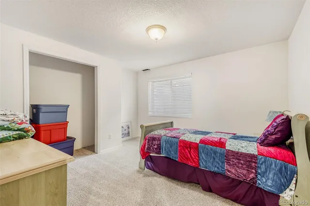 a bedroom with a bed and a dresser