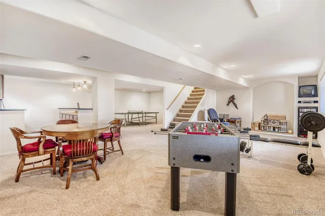 a view of a dining hall with furniture and a large window