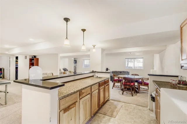 a kitchen with stainless steel appliances granite countertop sink stove and white cabinets