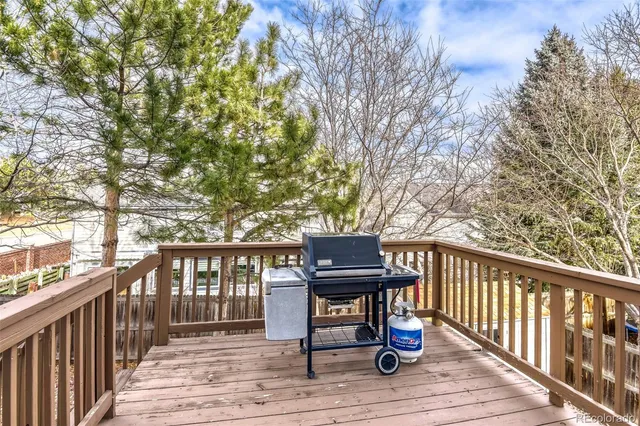 front view of a house with a large tree and a table and chairs
