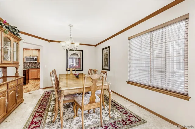 a dining room with wooden floor and a rug