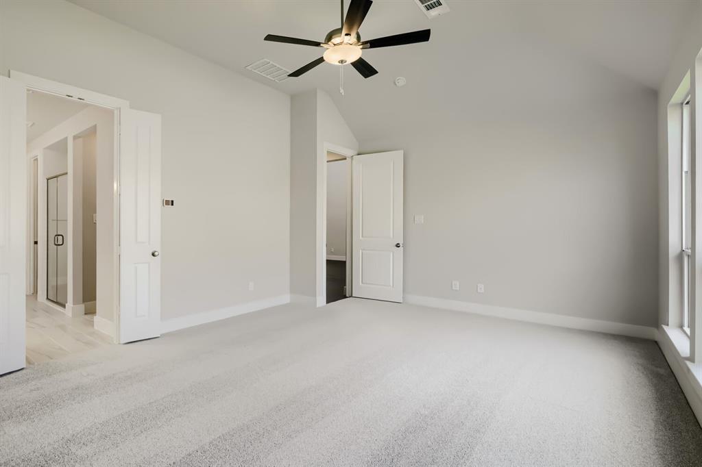 4407 Windy Point Road Oak Point, TX 75068 - Photo 11 of 27 Spacious room featuring vaulted ceilings, light-toned carpeting, and a ceiling fan