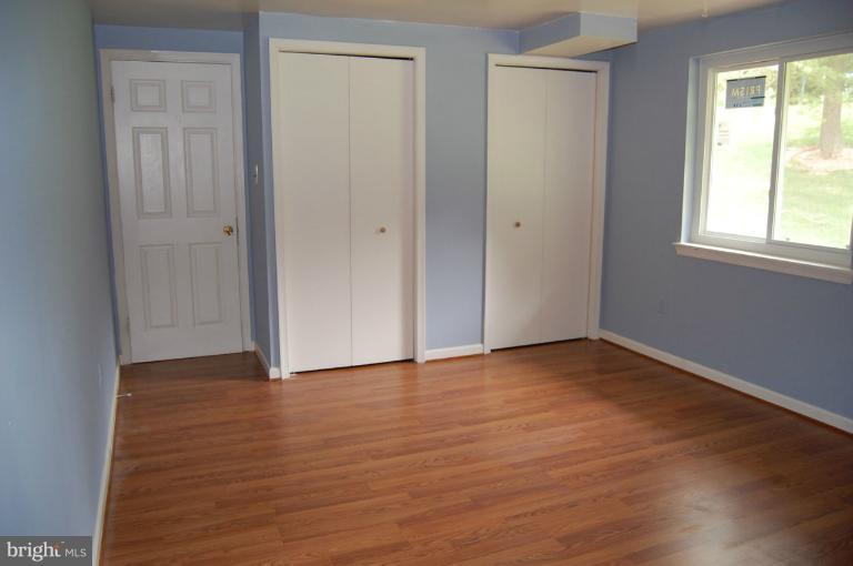14300 Morton Hall Road Silver Spring, MD 20906 - Photo 16 of 18 a view of an empty room with wooden floor and a window