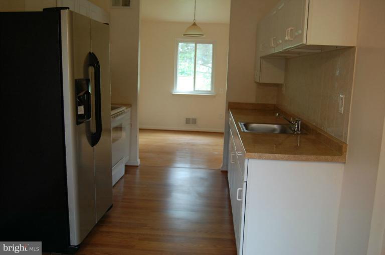 14300 Morton Hall Road Silver Spring, MD 20906 - Photo 4 of 18 a kitchen with granite countertop a refrigerator and a sink