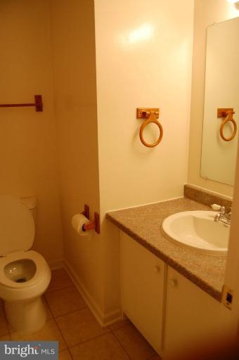 14300 Morton Hall Road Silver Spring, MD 20906 - Photo 5 of 18 a bathroom with a granite countertop toilet and a sink