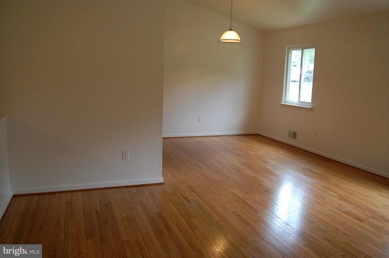 14300 Morton Hall Road Silver Spring, MD 20906 - Photo 7 of 18 an empty room with wooden floor and windows
