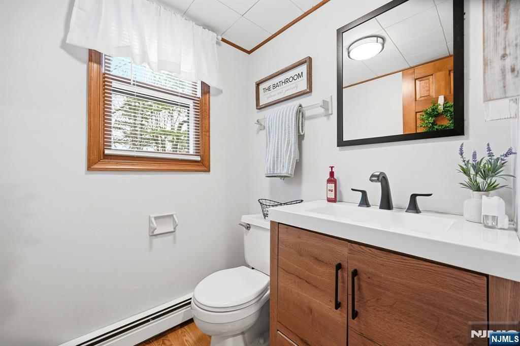 6 Robin Drive Oak Ridge, NJ 07438 - Photo 18 of 49 a bathroom with a granite countertop sink mirror vanity and toilet