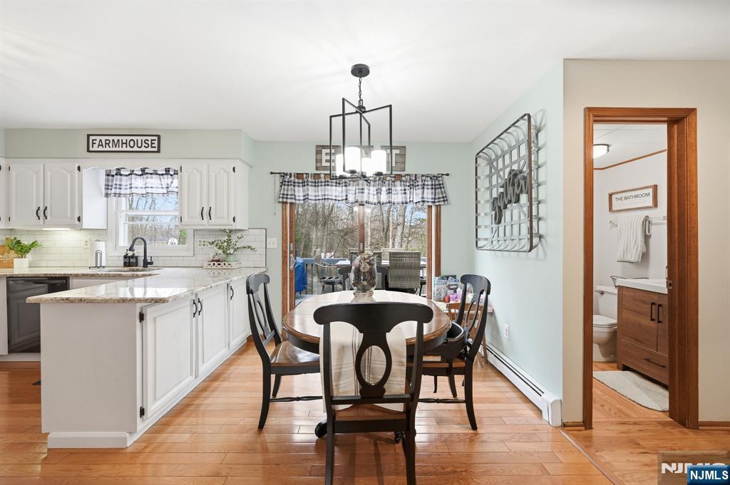 6 Robin Drive Oak Ridge, NJ 07438 - Photo 21 of 49 a dining room with furniture a chandelier and wooden floor