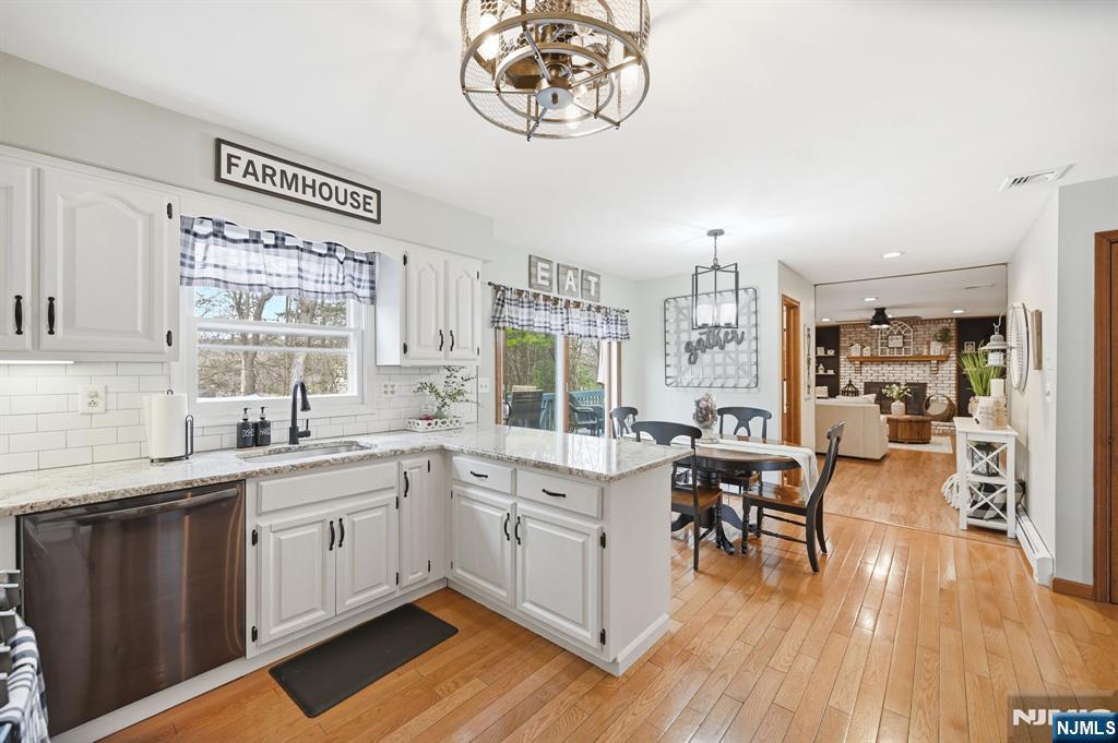 6 Robin Drive Oak Ridge, NJ 07438 - Photo 25 of 49 a kitchen with a sink cabinets and wooden floor