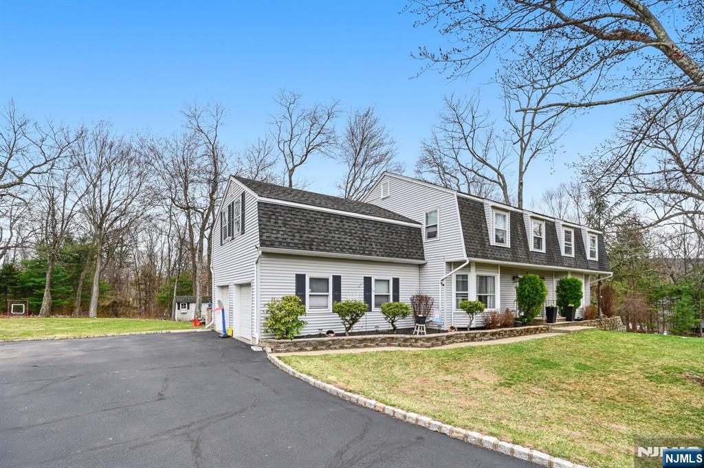 6 Robin Drive Oak Ridge, NJ 07438 - Photo 3 of 49 a front view of a house with garden and trees