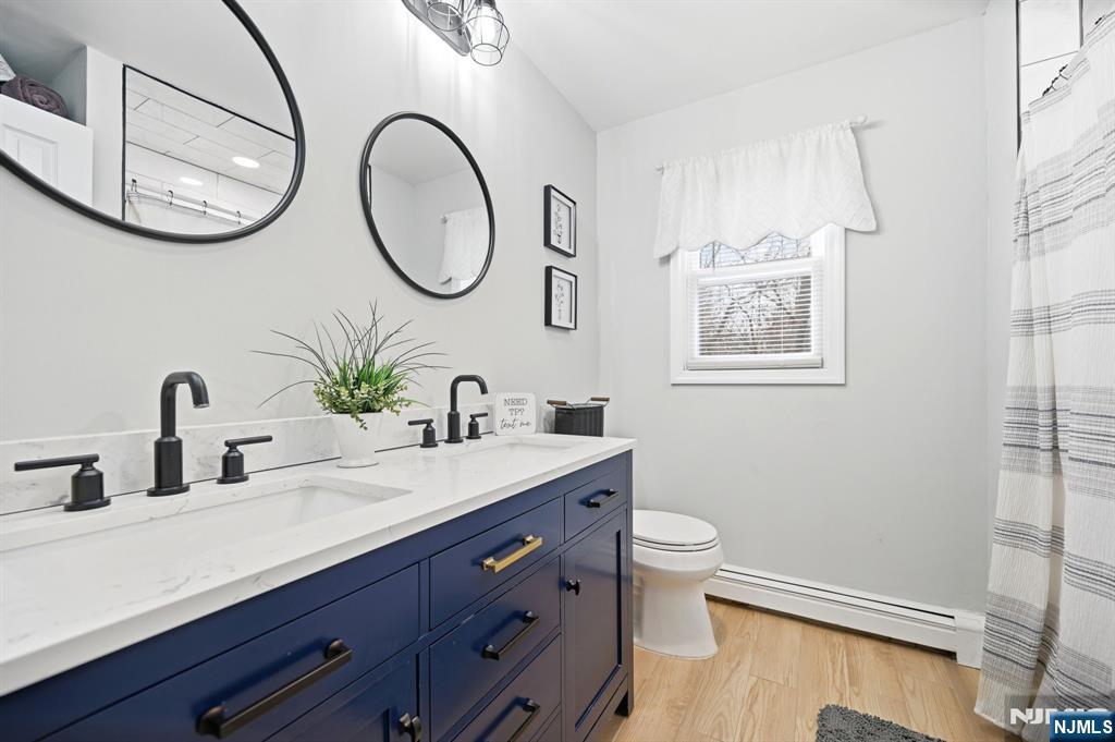 6 Robin Drive Oak Ridge, NJ 07438 - Photo 37 of 49 a bathroom with a toilet a sink and a mirror