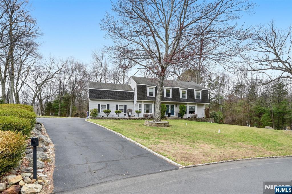 6 Robin Drive Oak Ridge, NJ 07438 - Photo 4 of 49 a view of a house with a big yard and large trees