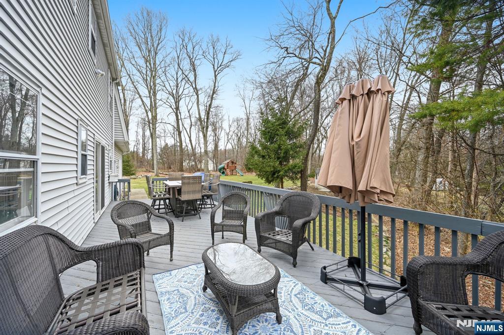 6 Robin Drive Oak Ridge, NJ 07438 - Photo 46 of 49 a view of a patio with couches table and chairs and potted plants