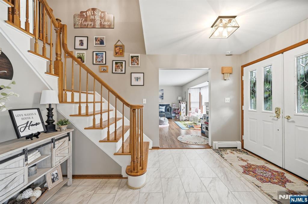 6 Robin Drive Oak Ridge, NJ 07438 - Photo 6 of 49 a view of entryway and hall with wooden floor