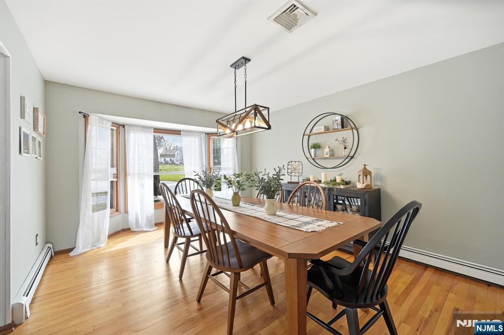 6 Robin Drive Oak Ridge, NJ 07438 - Photo 10 of 49 a view of a dining room with furniture window and wooden floor