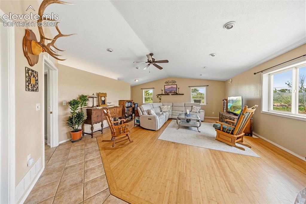 13075 Blaney Road South Peyton, CO 80831 - Photo 12 of 40 Family room as is featuring spacious living area, wood-finish flooring, recessed lighting, and multiple windows