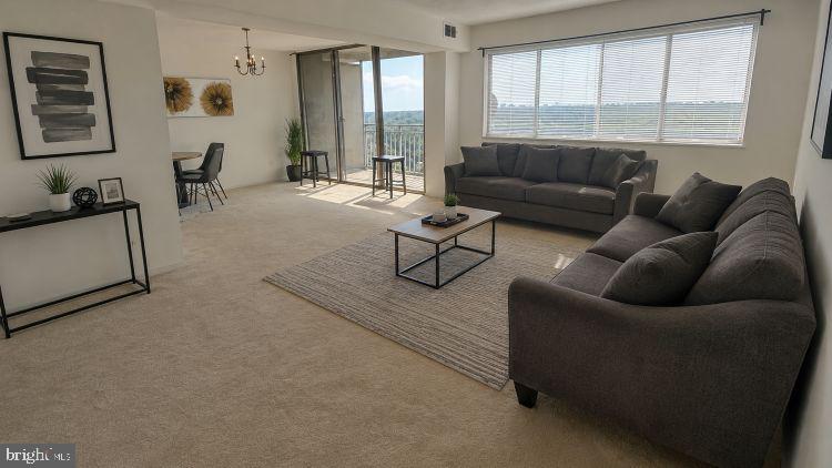 1836 Metzerott Road, Unit 1720 Hyattsville, MD 20783 - Photo 5 of 35 a living room with furniture and a large window
