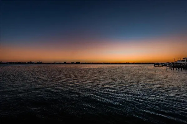 a view of a balcony with wooden floor and city view