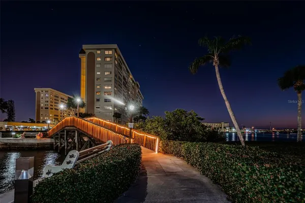 a living room with furniture a large window and a table