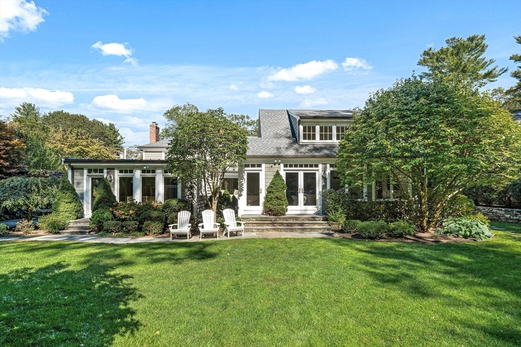 27 Radcliffe Road Wellesley, MA 02482 - Photo 31 of 38 a front view of a house with a garden and trees
