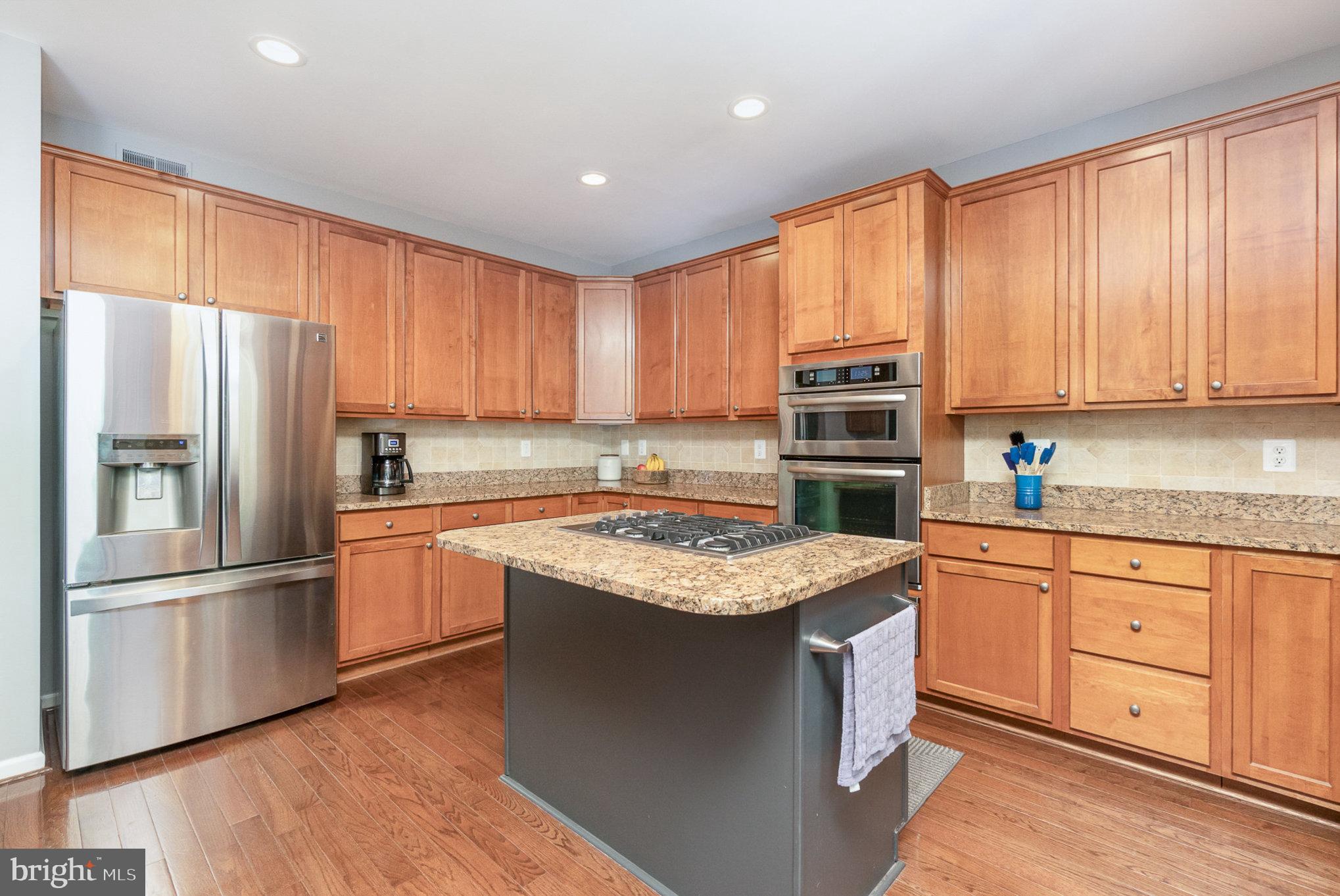 1326 Eagle Ridge Run Bel Air, MD 21014 - Photo 16 of 79 a kitchen with stainless steel appliances granite countertop a refrigerator stove top oven and large window