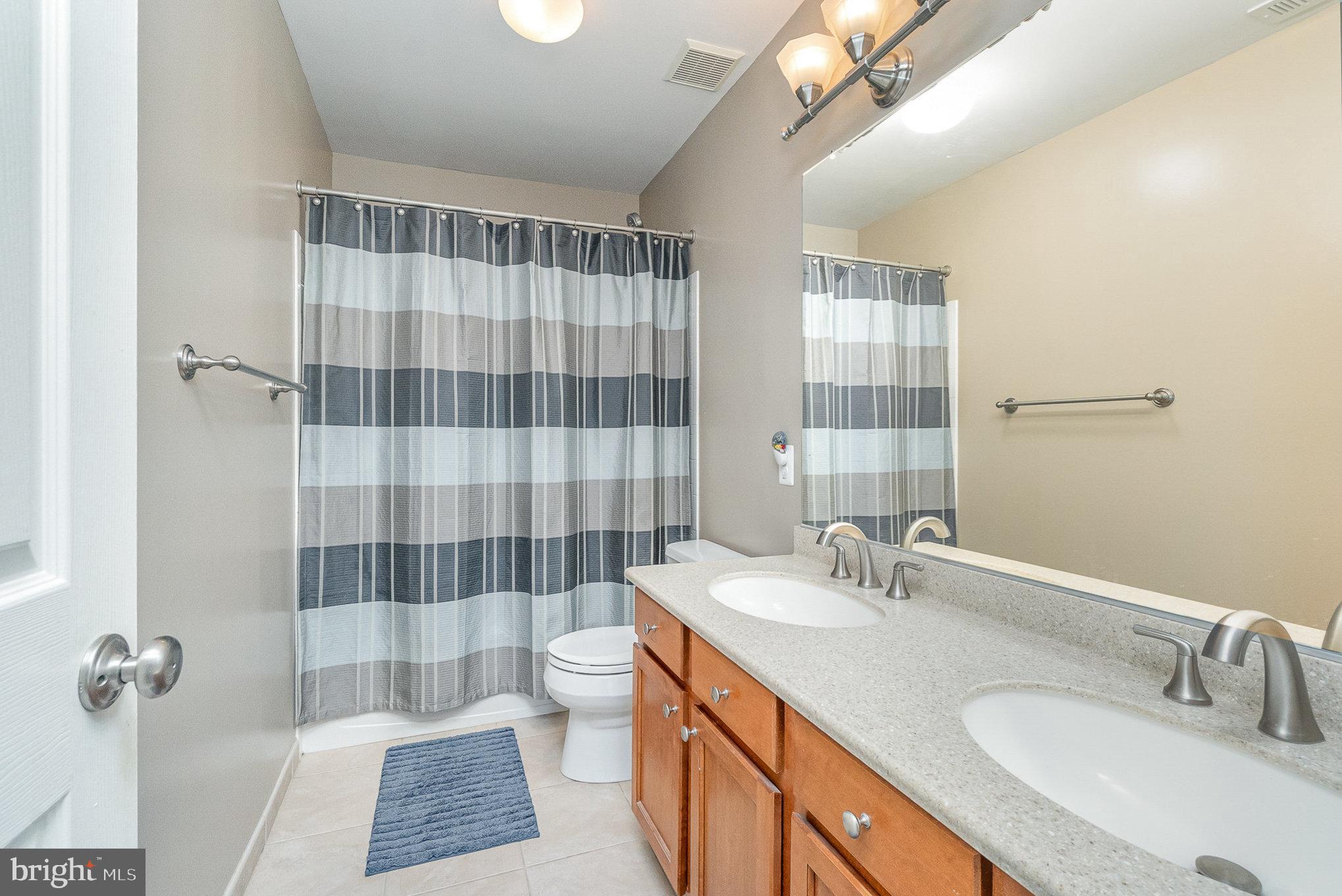 1326 Eagle Ridge Run Bel Air, MD 21014 - Photo 45 of 79 a bathroom with a double vanity sink toilet mirror and shower