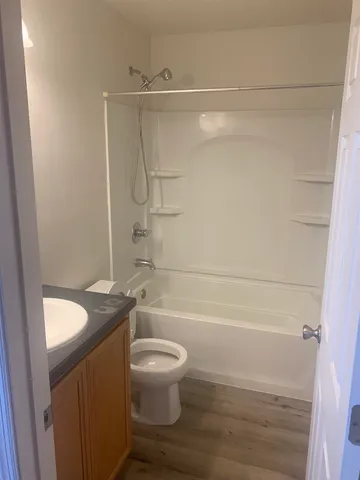 a bathroom with a granite countertop bathtub shower