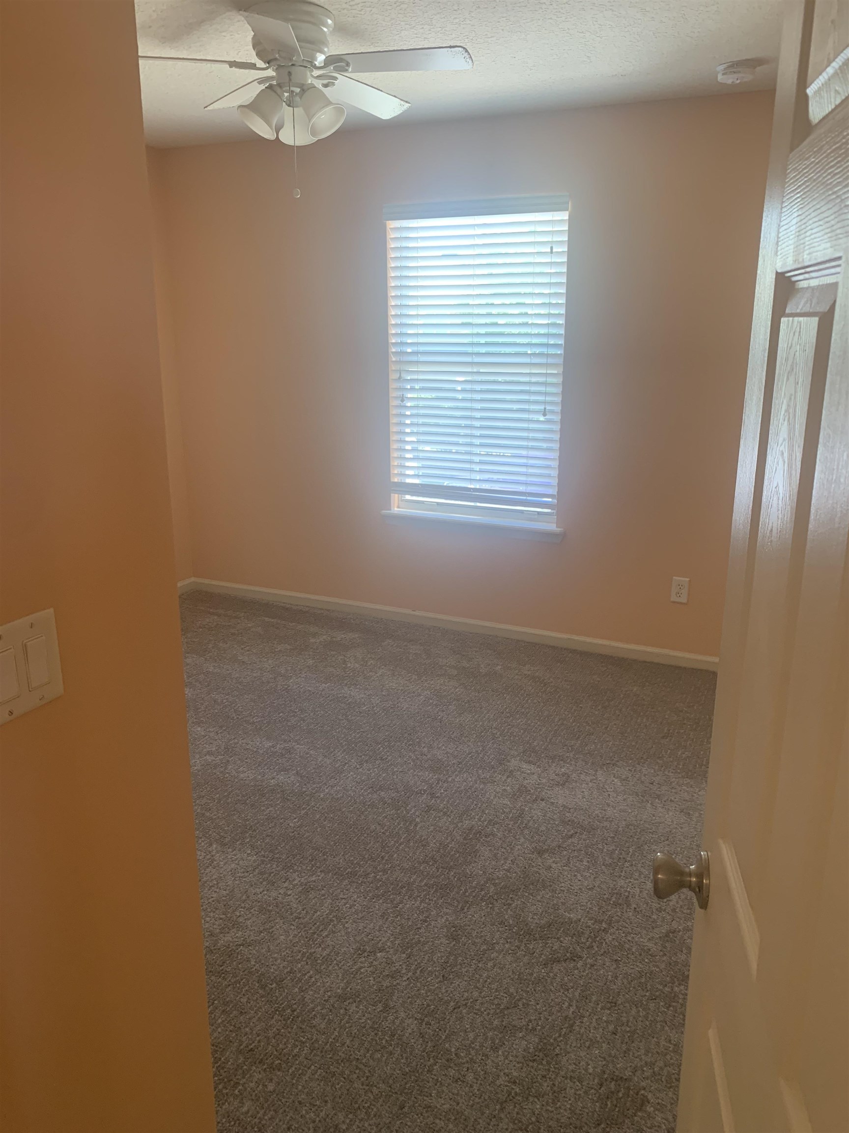 200 Sienna Place St. Augustine, FL 32084 - Photo 14 of 24 an empty room with a chandelier fan and windows