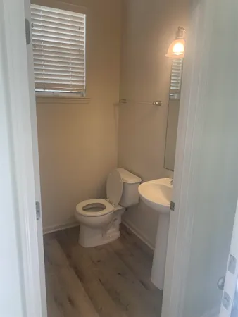 a white toilet sitting next to a bathroom sink