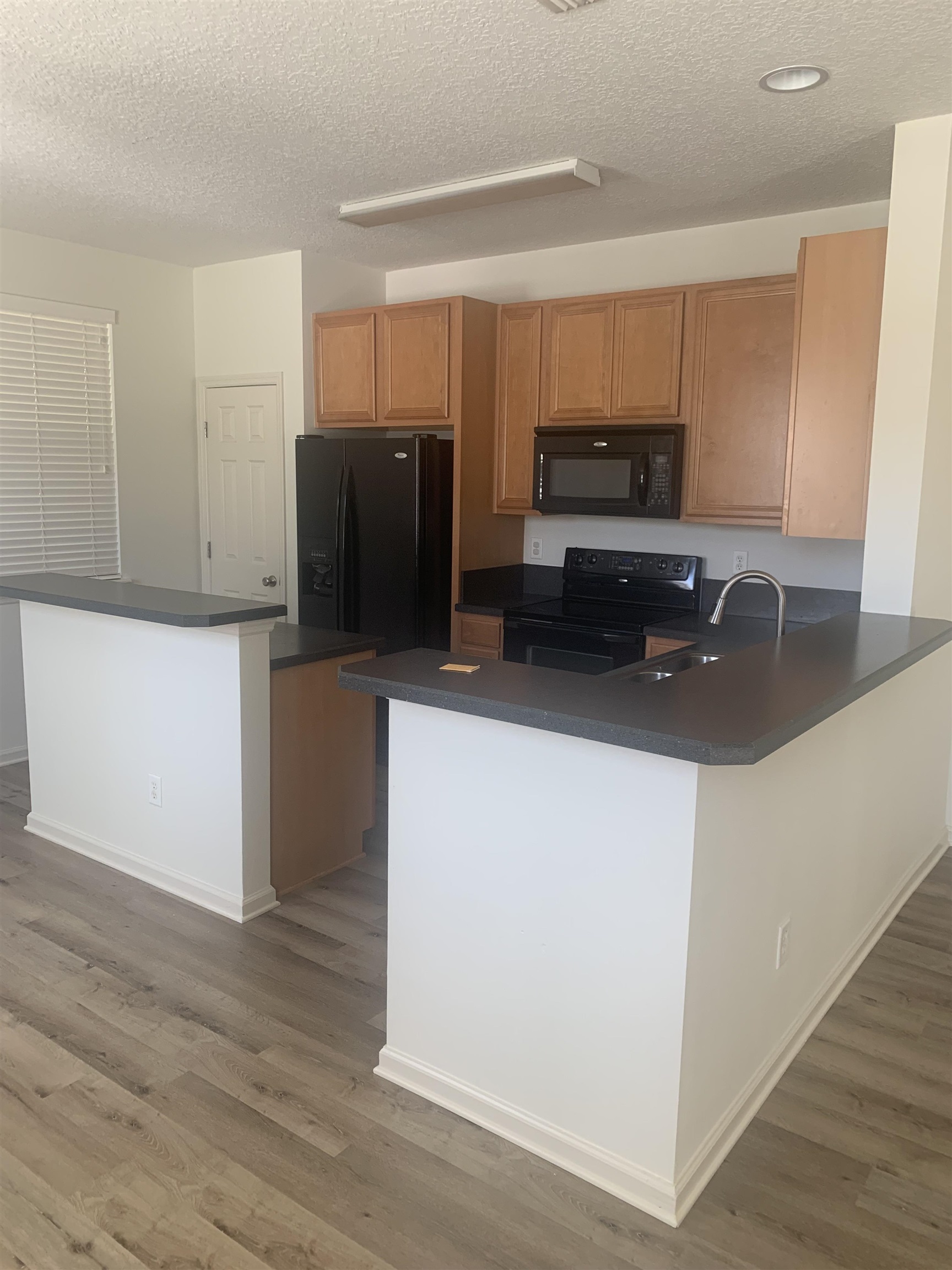 200 Sienna Place St. Augustine, FL 32084 - Photo 9 of 24 a kitchen with stainless steel appliances a refrigerator a stove a microwave and cabinets